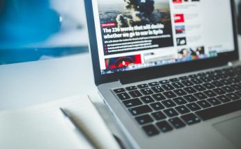 gray laptop computer near journals